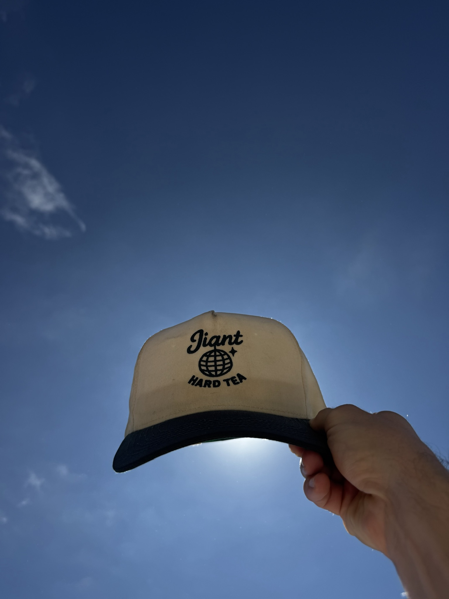 Jiant Hard Tea hat against the sky